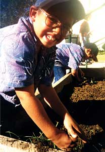 Student planting seedlings during a Science and Technology activity