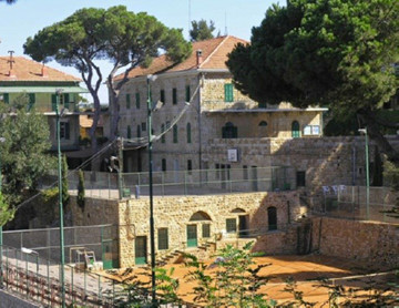 Picture of a large house with a tennis court