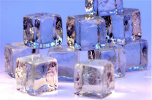 10 cubes made of ice. Several are loosely stacked on each other which others are just on a flat surface.